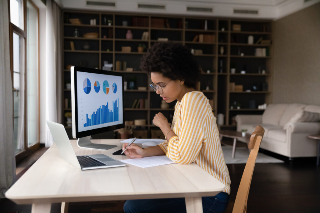 A marketer works at her desk on her budget during an economic downturn.